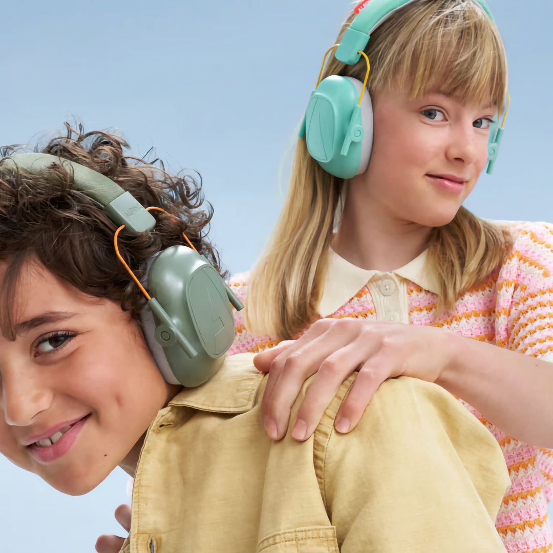 Two children wearing Alpine Muffy Kids Earmuffs in green and mint, providing noise protection and comfort for kids aged 5–16 during various activities.