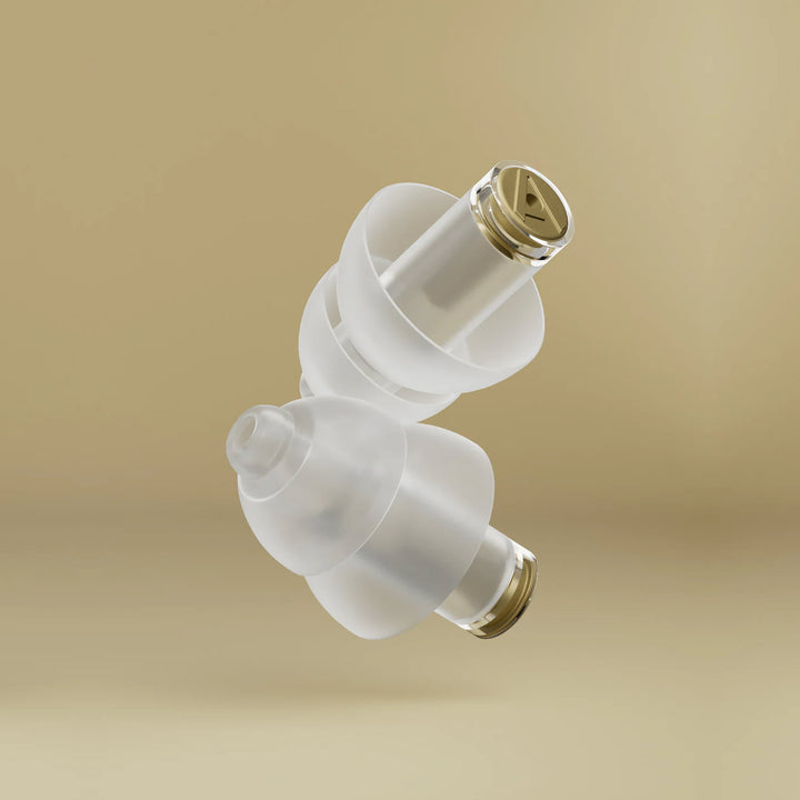 Close-up of Alpine MusicSafe Pro earplugs with transparent design and gold music filter for safe and clear sound protection