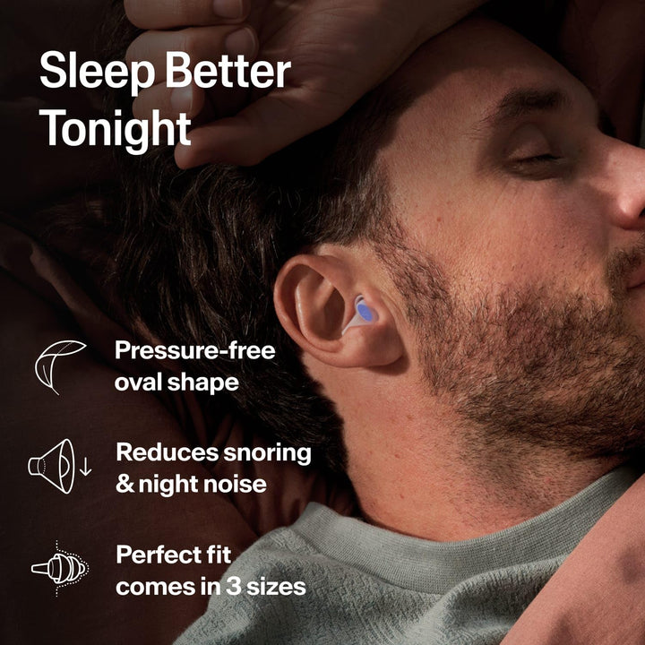 Man wearing Alpine SleepDeep sleeping earplug in bed, highlighting its oval shape, noise reduction and three sizes