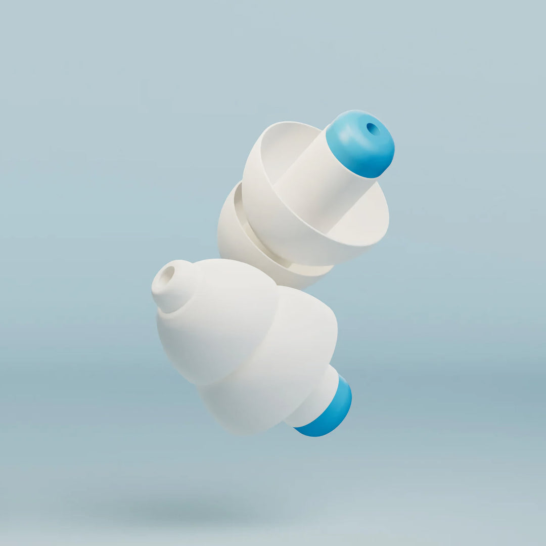 Close-up of two Alpine SwimSafe white and blue swimming earplugs on a light blue background