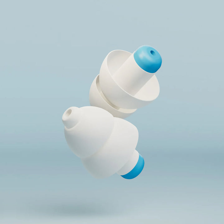 Close-up of two Alpine SwimSafe white and blue swimming earplugs on a light blue background