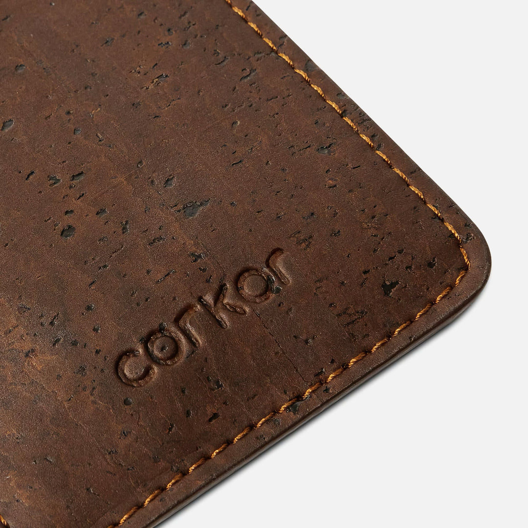 Close-up detail of the Corkor CK241 dark brown vegan cork card sleeve wallet, showcasing the natural cork texture and debossed Corkor logo in a sustainable, minimalist design.