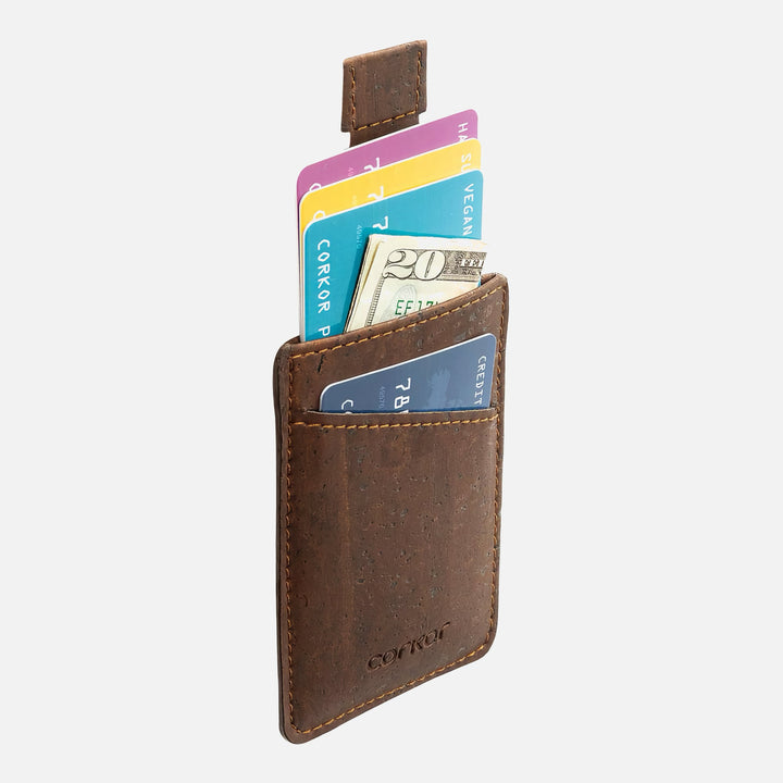 Side view of Corkor CK241 dark brown vegan cork card sleeve wallet, showcasing multiple cards and cash in a compact, eco-friendly design with pull-tab feature for easy access.