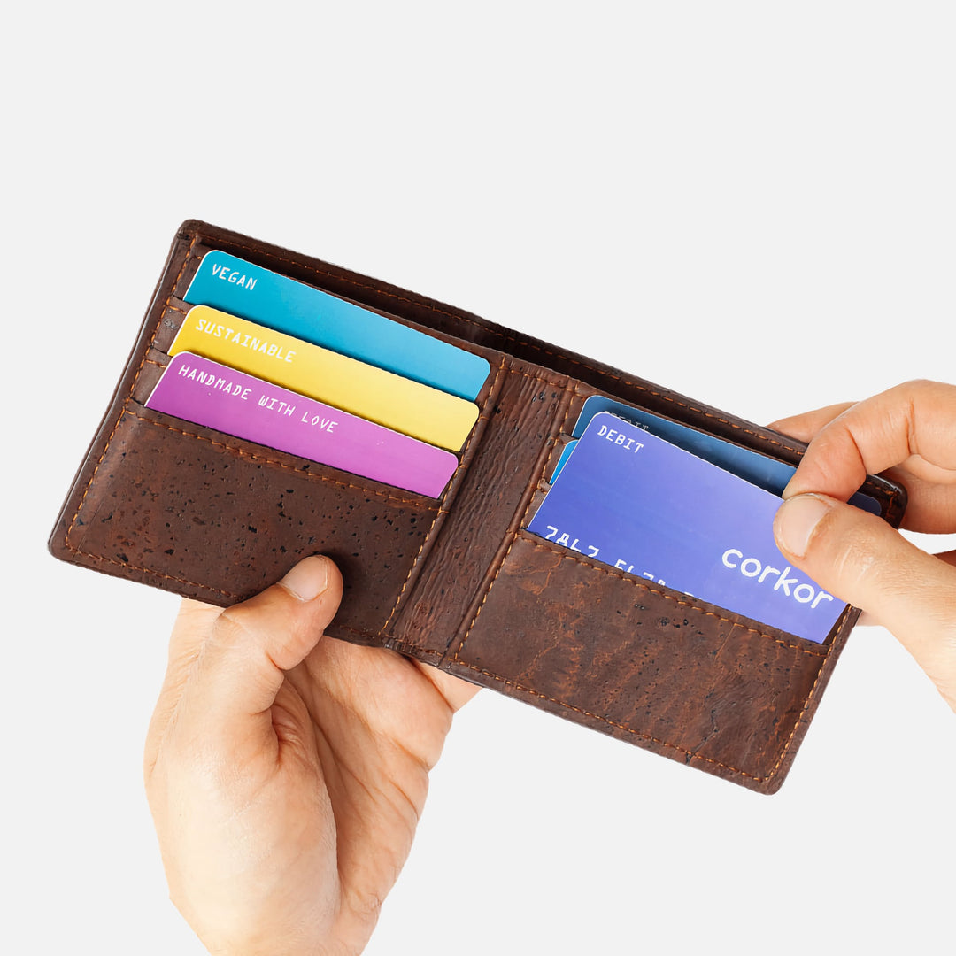 Corkor vegan cork bifold wallet shown with hands inserting cards, highlighting convenient and organized card slots.