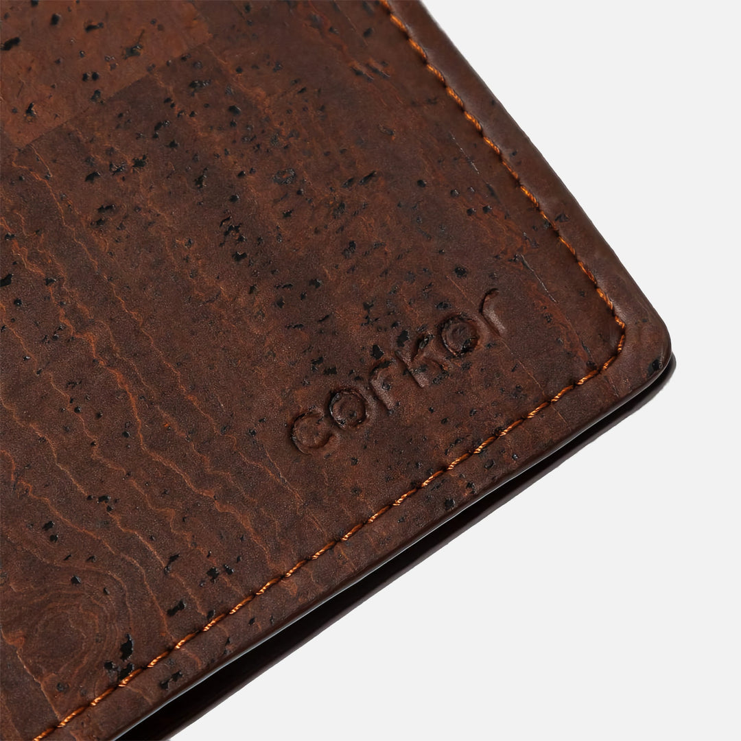 Close-up of Corkor vegan cork bifold wallet, showcasing the debossed Corkor logo on the dark brown cork leather texture.