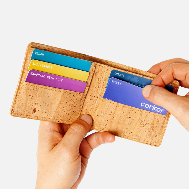 Corkor vegan cork bifold wallet shown with hands inserting cards, highlighting convenient and organized card slots.