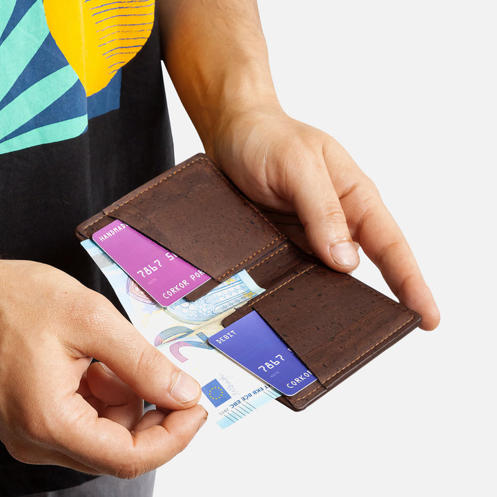 Person taking cash from Corkor Vegan Cork Slim Wallet CK261 in dark brown, highlighting card slots and bill compartment.