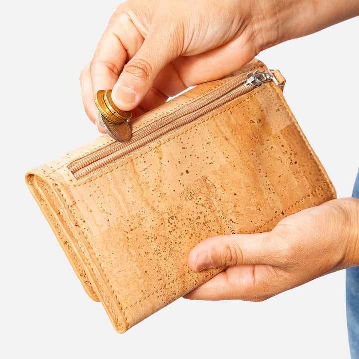 Corkor Vegan Cork Women's Slim Wallet with a secure zippered pocket, perfect for storing coins, shown in use.