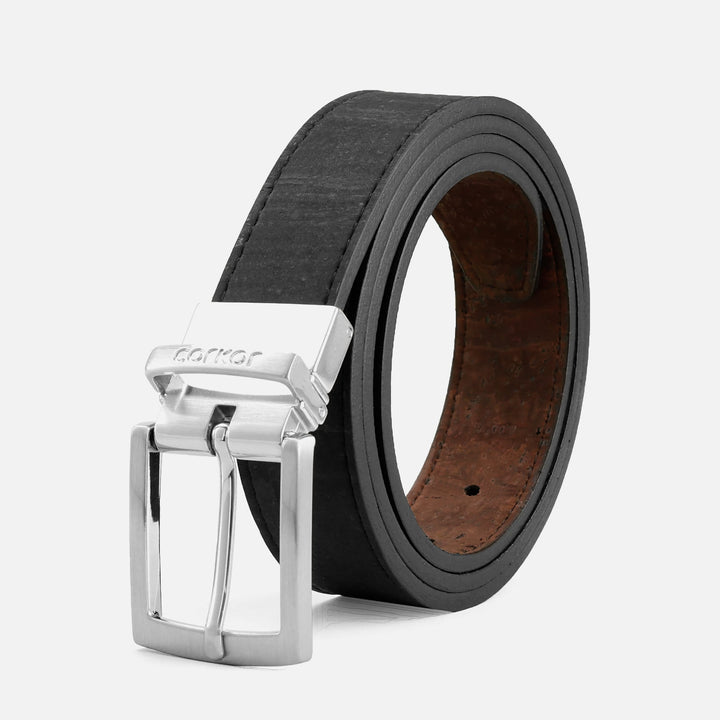 Corkor black belt with brown underside and silver buckle, shown rolled in a studio product shot