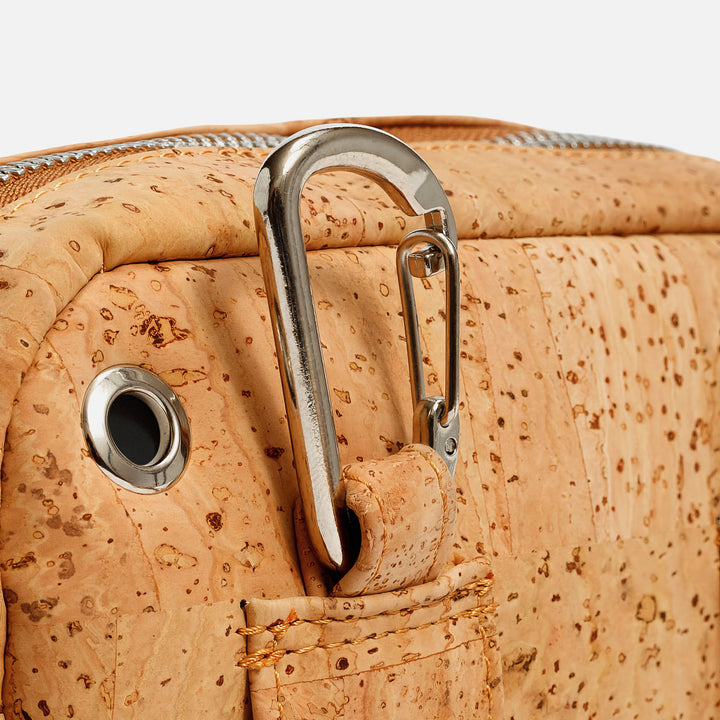 Close-up of Corkor Vegan Cork Crossbody Pouch Horizontal in light brown cork leather showing carabiner clip and earphone hole