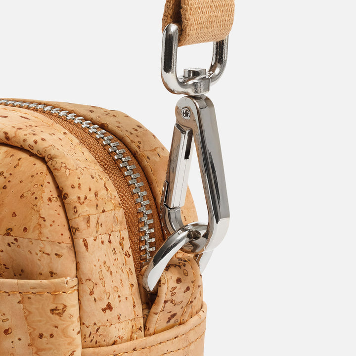 Close-up of Corkor Vegan Cork Crossbody Pouch Horizontal in light brown cork leather showing metal strap clip and zipper detail