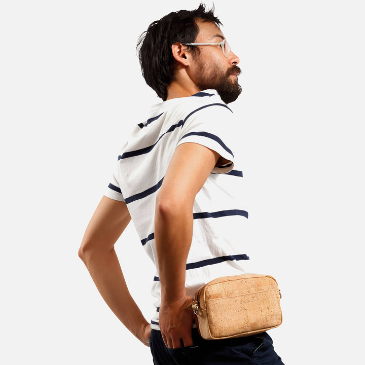 Male model wearing Corkor Vegan Cork Crossbody Pouch Horizontal in light brown as a belt pouch for hands-free carry