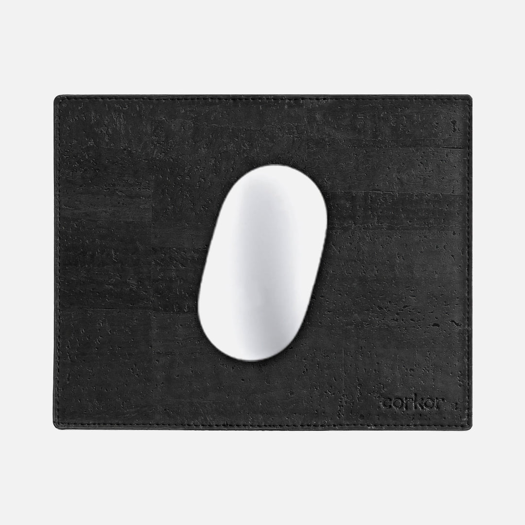 Corkor black mouse pad with stitched edges and embossed logo, shown from above with a white mouse