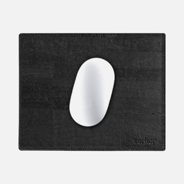 Corkor black mouse pad with stitched edges and embossed logo, shown from above with a white mouse