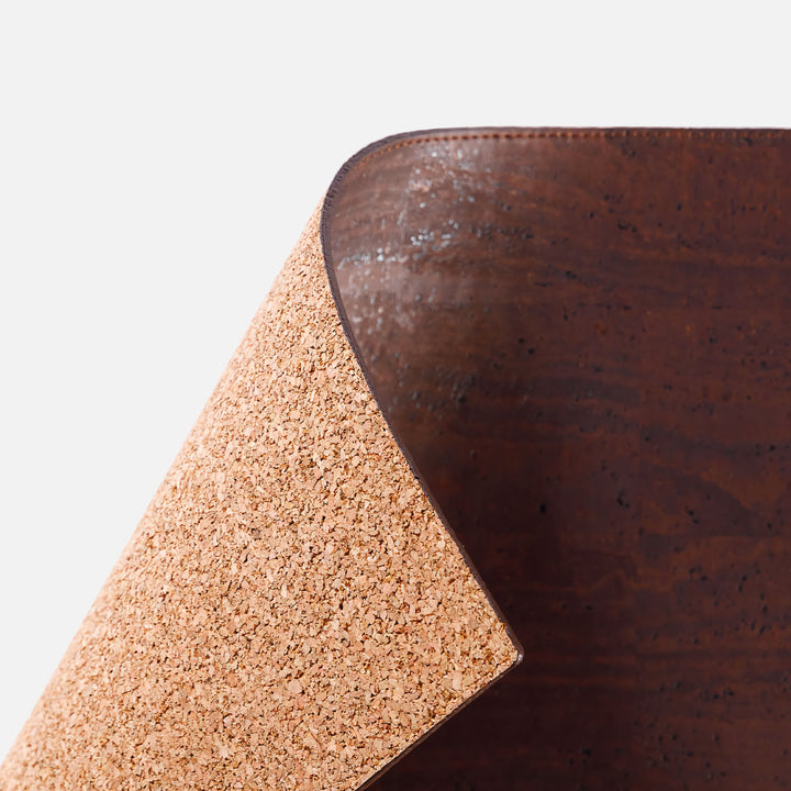 Close-up of Corkor dark brown mouse pad with a lifted corner showing the cork-textured backing