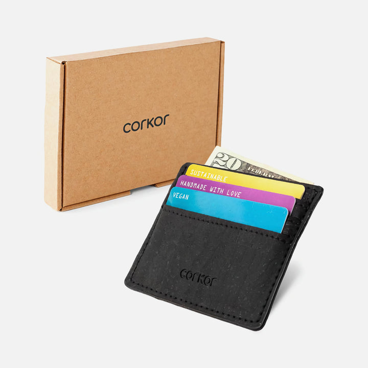 Corkor Vegan Cork Slim Cardholder in black shown with eco-friendly cardboard packaging, displaying cards and cash