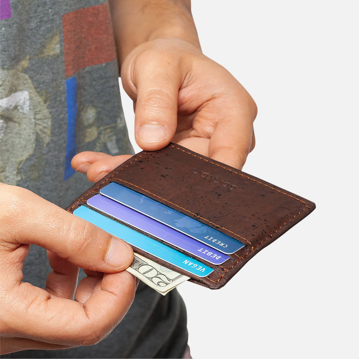 Person holding the dark brown Corkor Vegan Cork Slim Cardholder with cards and cash, showing slim, minimalist, and eco-friendly design