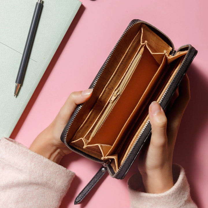 Hands opening Corkor Vegan Cork Women's Long Wallet in black, showcasing its organized interior and spacious compartments.