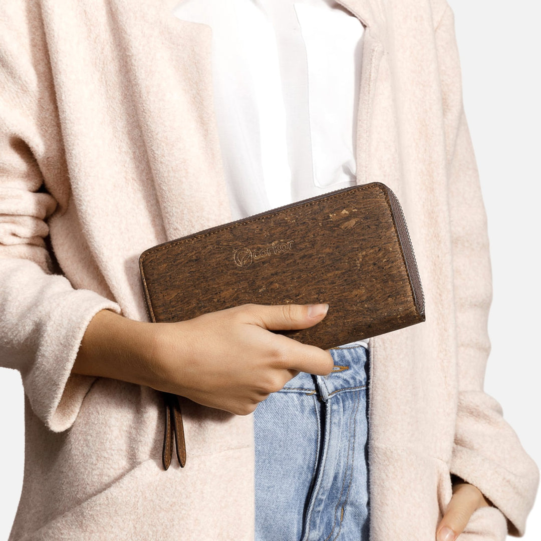 Woman holding Corkor Vegan Cork Women's Long Wallet in trunk finish, highlighting its natural cork texture and elegant design.