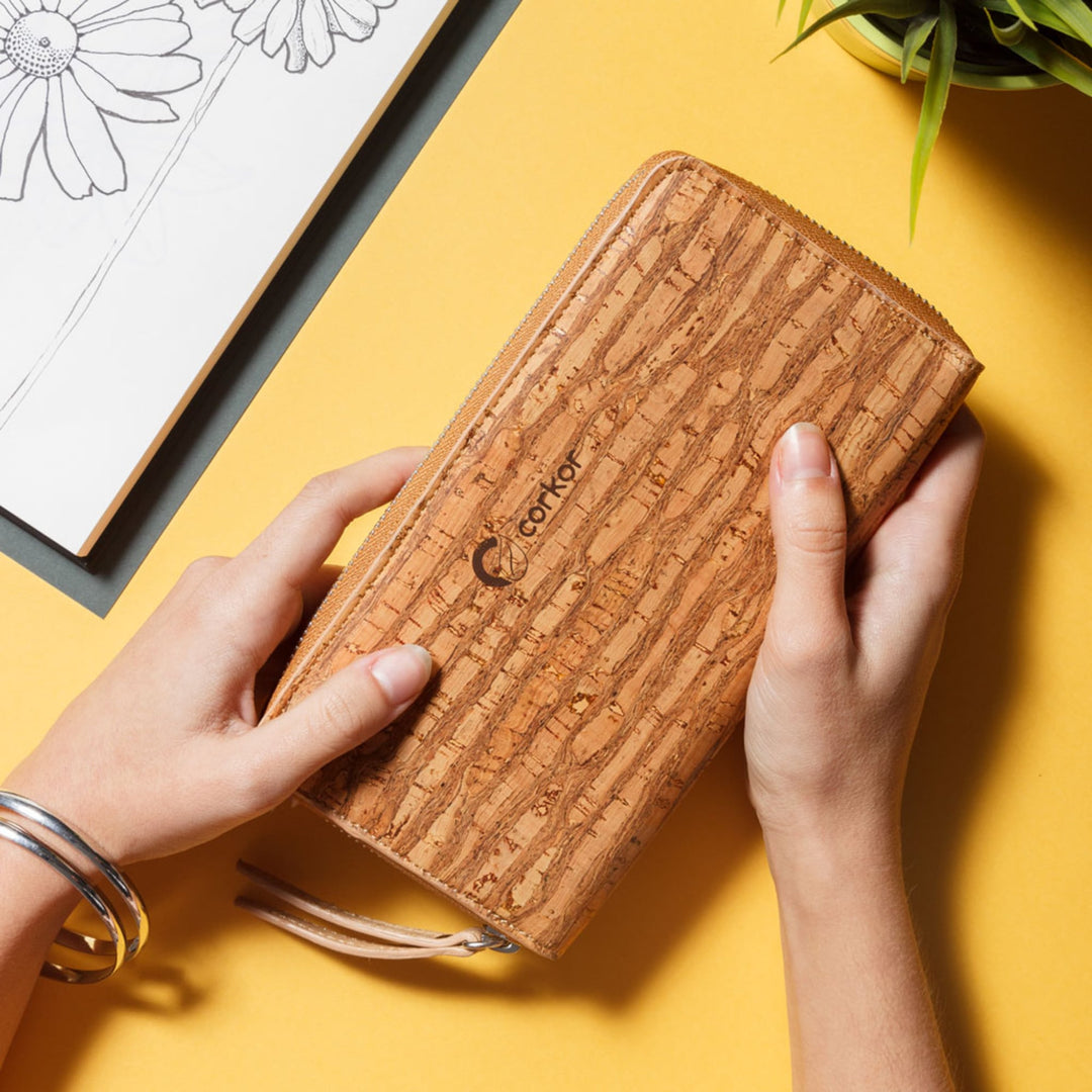 Hands holding Corkor Vegan Cork Women's Long Wallet in zebra finish, highlighting its sustainable material and unique cork texture.