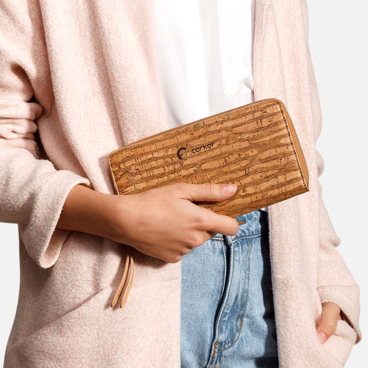 Woman holding Corkor Vegan Cork Women's Long Wallet in zebra finish, highlighting its unique pattern and eco-friendly design.