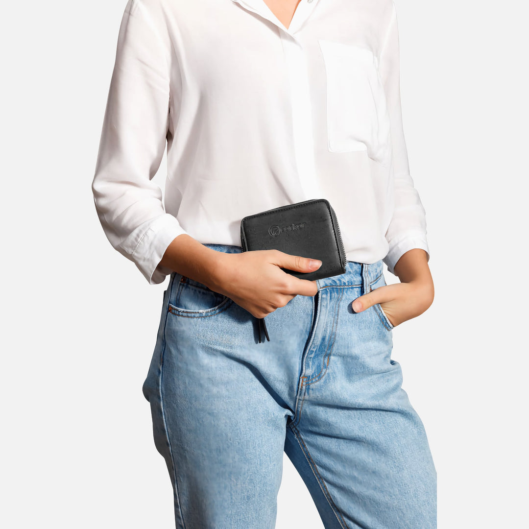 Corkor black cork square wallet held by hand with white shirt and jeans