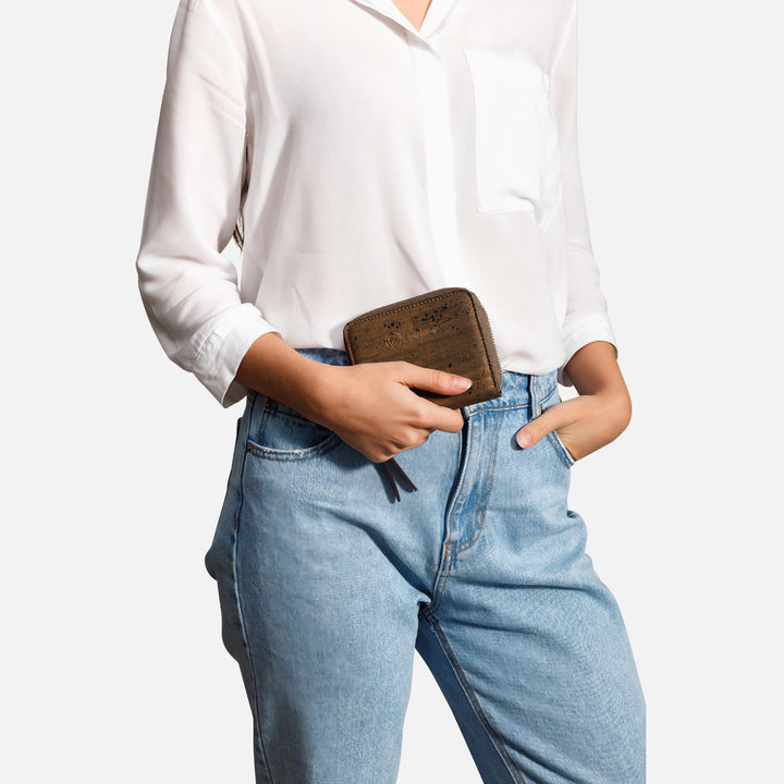 Corkor dark brown cork square wallet held by hand with white shirt and jeans