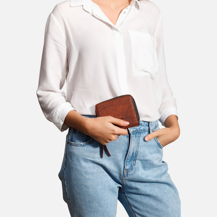 Corkor red cork square wallet held by hand with white shirt and jeans
