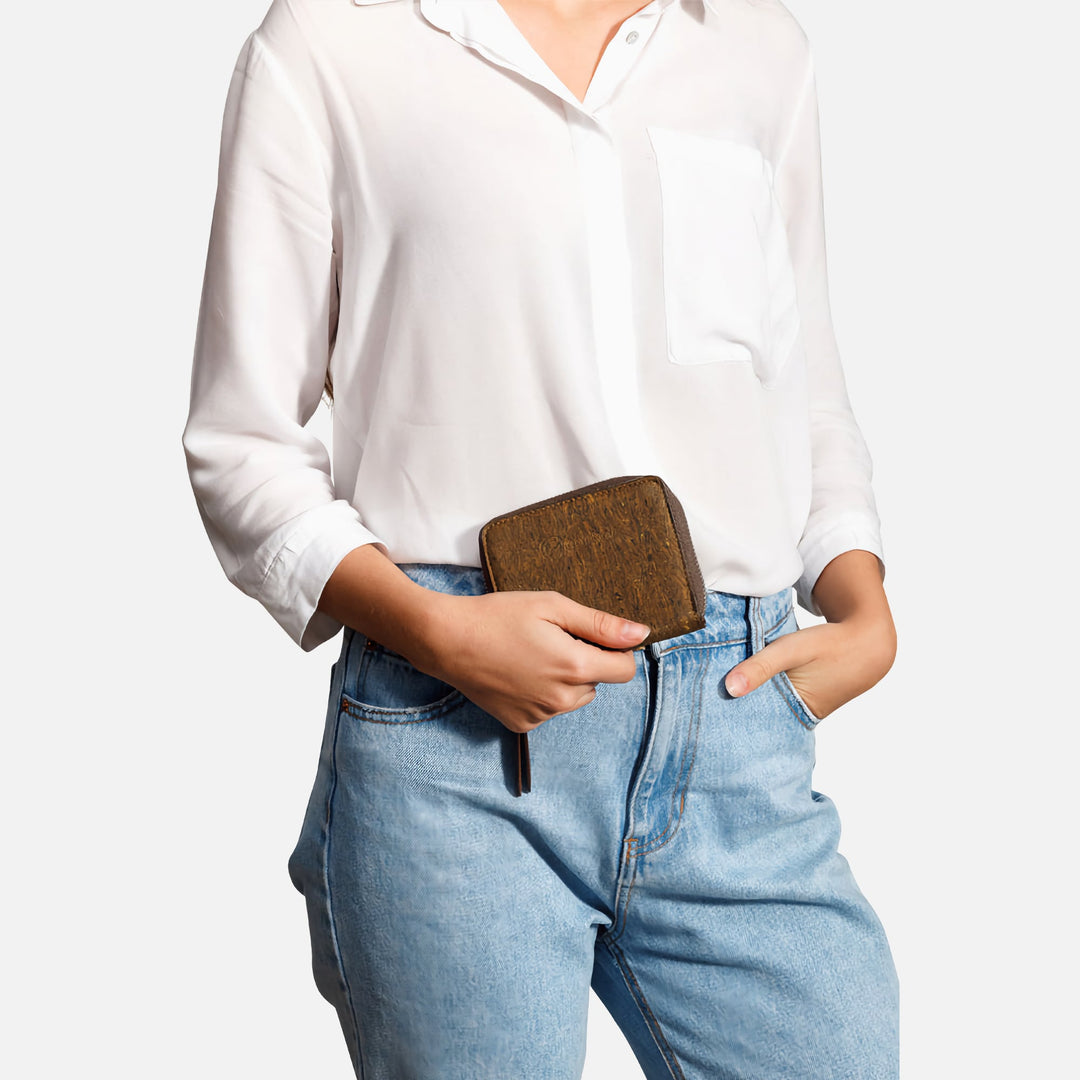 Corkor trunk cork square wallet held by hand with white shirt and jeans