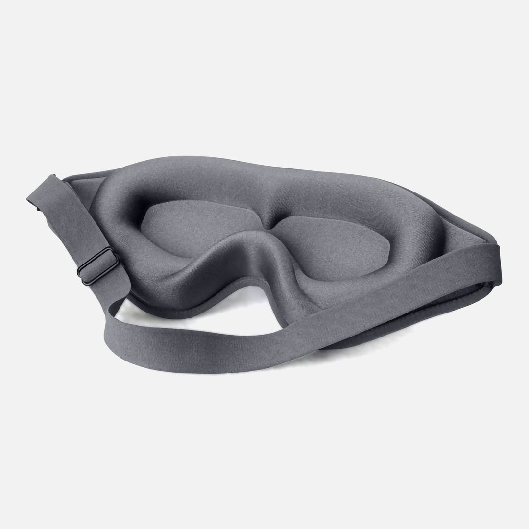 DreamEase 3D Sleep Mask in gray, featuring ergonomic design, memory foam, and light-blocking benefits for restful sleep.