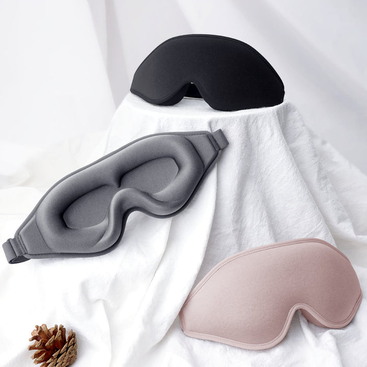 DreamEase 3D Sleep Mask available in black, gray, and pink, offering stylish options with superior comfort and light-blocking features.