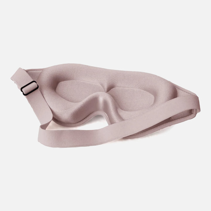 DreamEase 3D Sleep Mask in pink, featuring ergonomic design, memory foam, and light-blocking benefits for restful sleep.