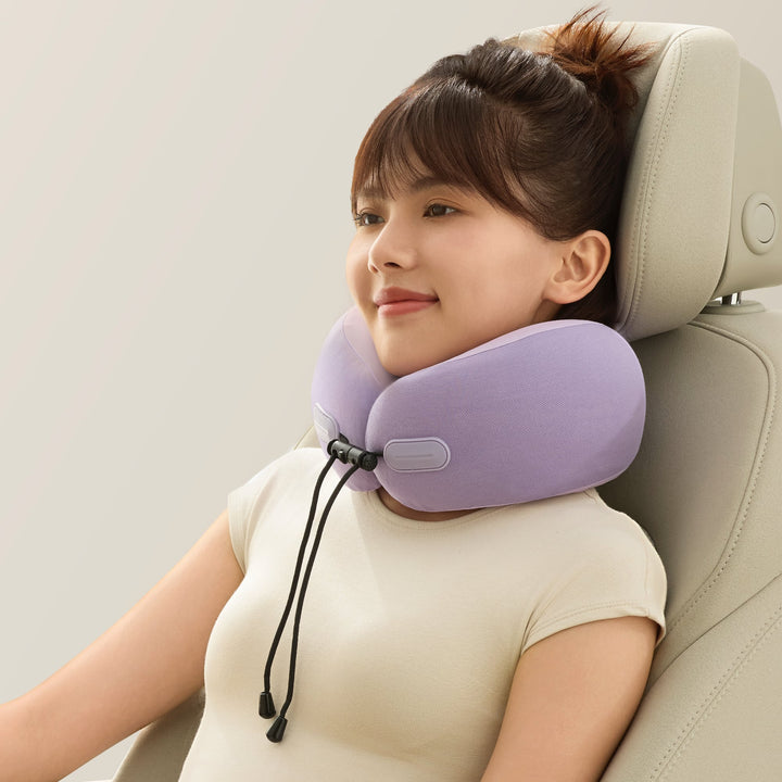 Woman using the EVERYTHINK ES2 purple travel neck pillow while resting comfortably in a car seat