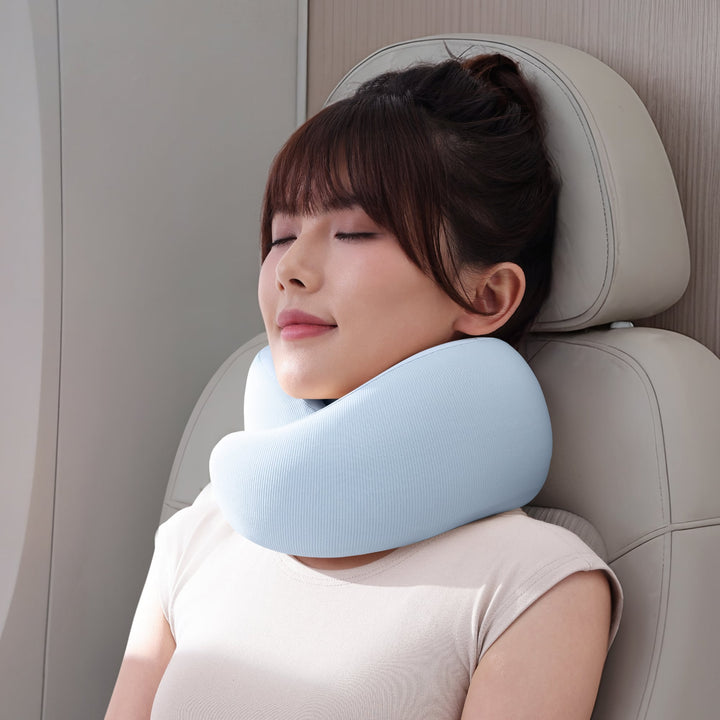 EVERYTHINK ES3 Travel U-Pillow in blue, shown in use during a flight for neck support and comfort