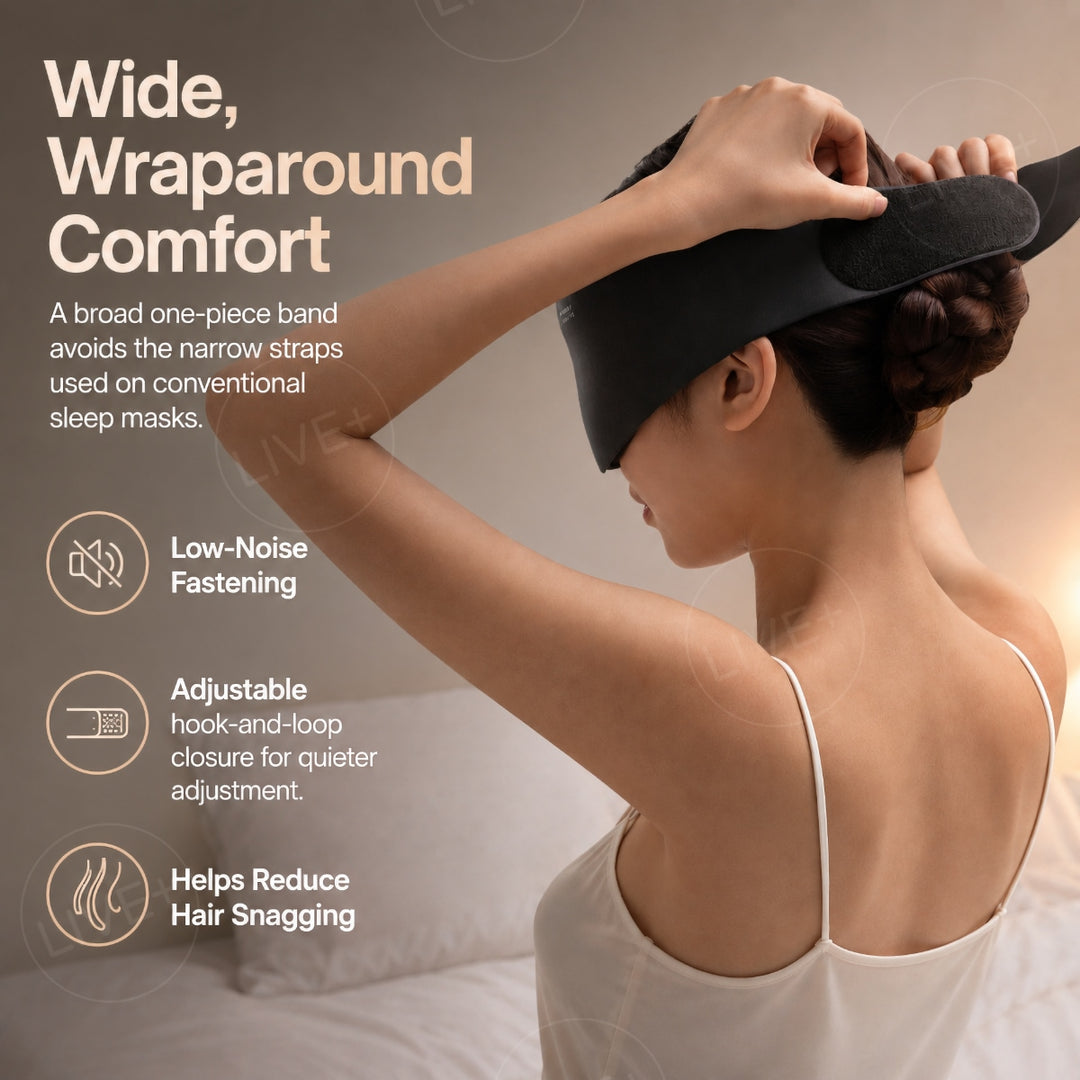 Woman adjusting a black sleep mask with a wide wraparound band and hook-and-loop fastening at the back