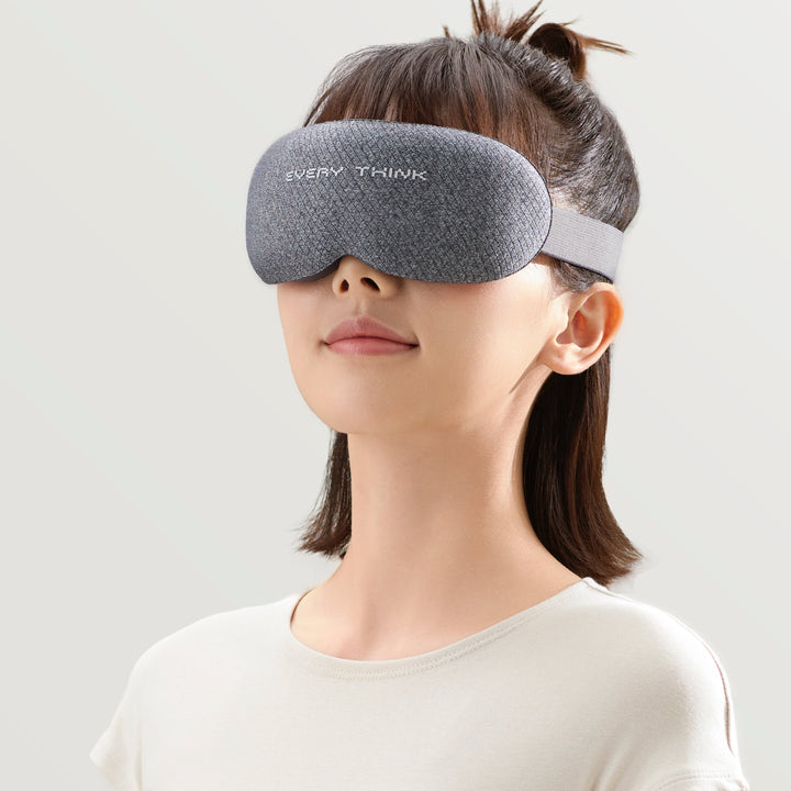Woman wearing EVERYTHINK VE2 3D blackout sleep mask in gray, shown from the front