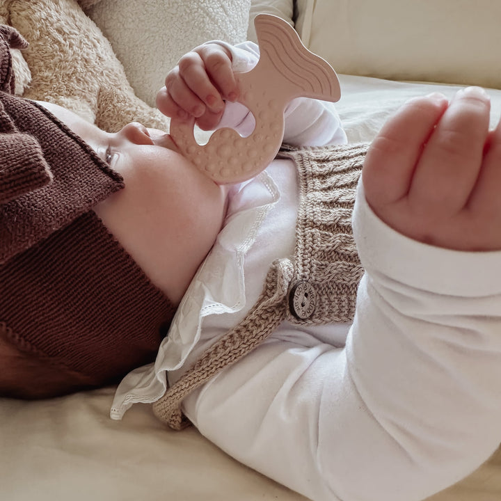 Baby using HEVEA Fish Teether in Powder Pink, natural rubber teether for soothing sore gums during teething