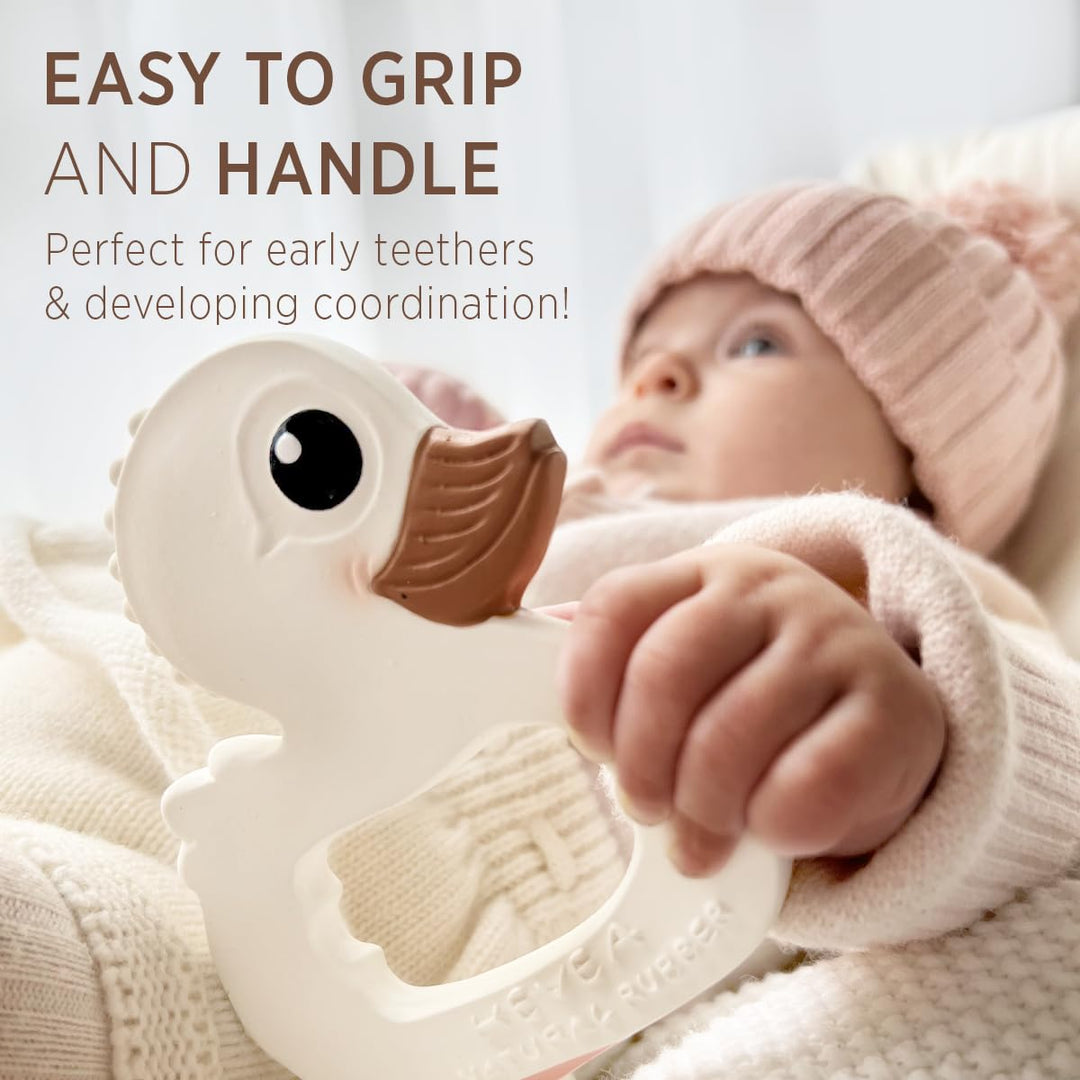 Baby holding HEVEA Kawan Duck Teether, easy to grip and perfect for early teethers and developing hand coordination