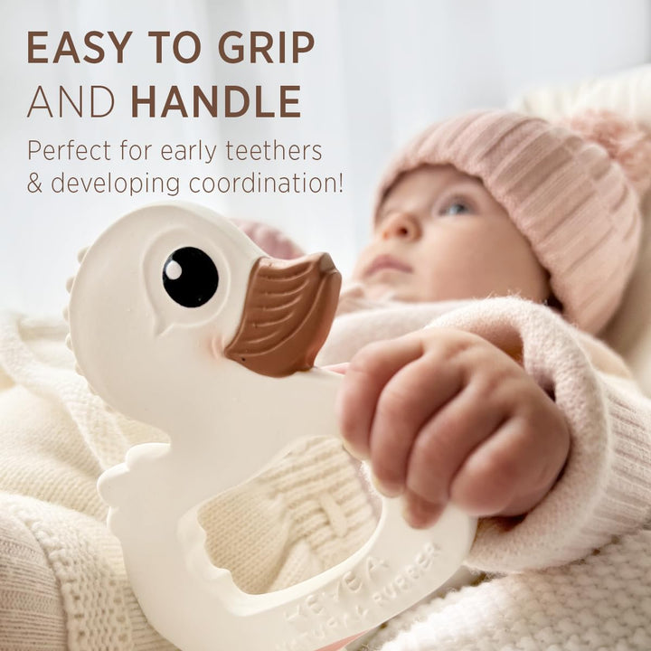 Baby holding HEVEA Kawan Duck Teether, easy to grip and perfect for early teethers and developing hand coordination