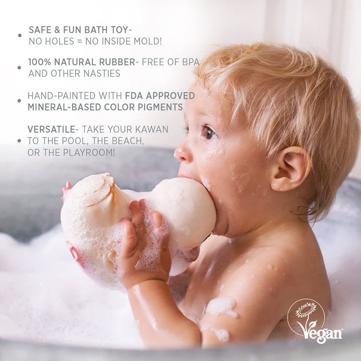 Baby playing with HEVEA Kawan Rubber Duck in a bubble bath, showcasing its natural, mold-free, and BPA-free design.