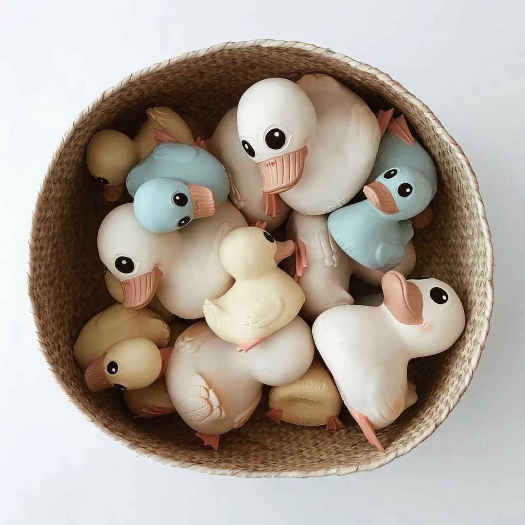 A basket filled with HEVEA Kawan Rubber Ducks in various colors, made from natural rubber with a safe, eco-friendly design.