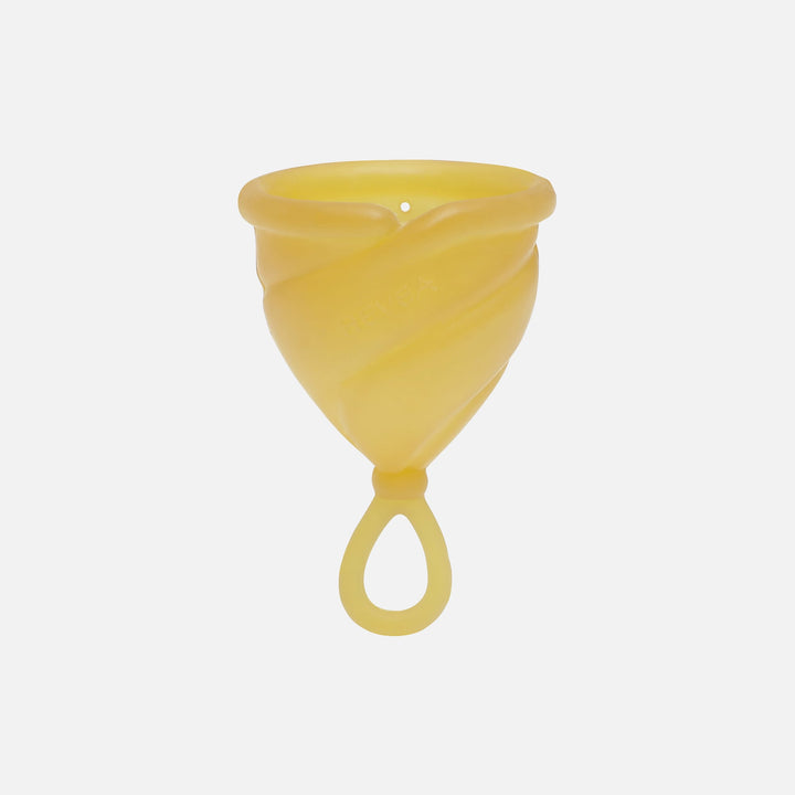 Hevea Loop Menstrual Cup in natural rubber color with soft loop stem for easy removal.