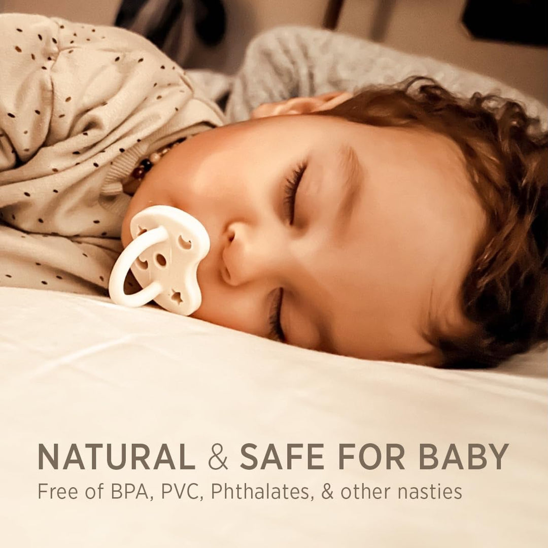 Baby sleeping with cream natural rubber pacifier in a soft bedtime lifestyle setting