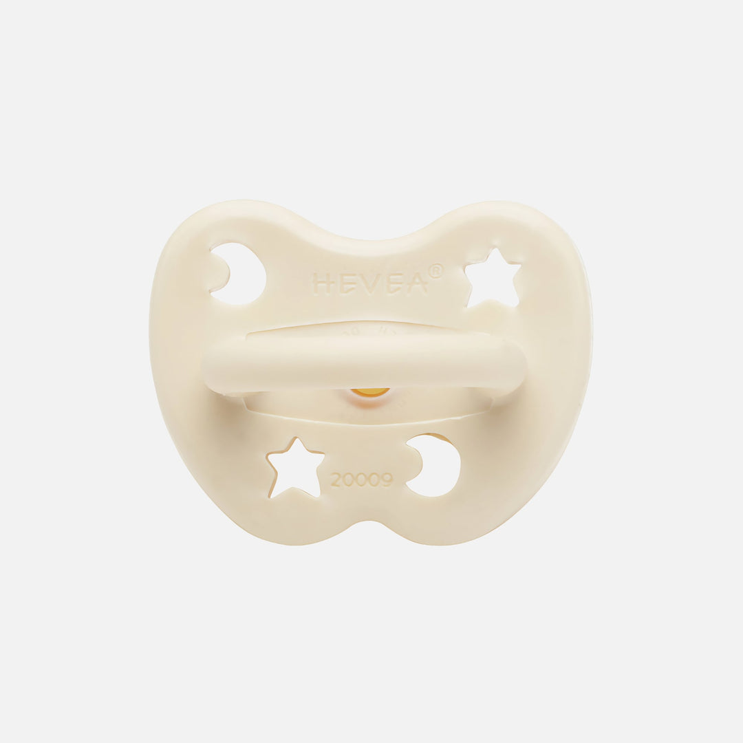 Hevea milky white pacifier back view with moon and star ventilation holes
