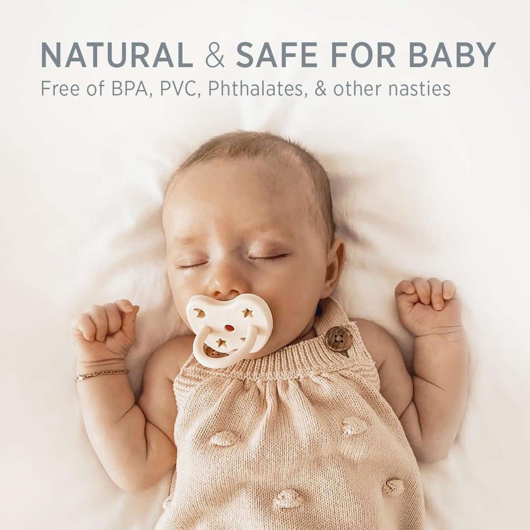 Baby using a milky white Hevea natural rubber pacifier in a soft lifestyle scene