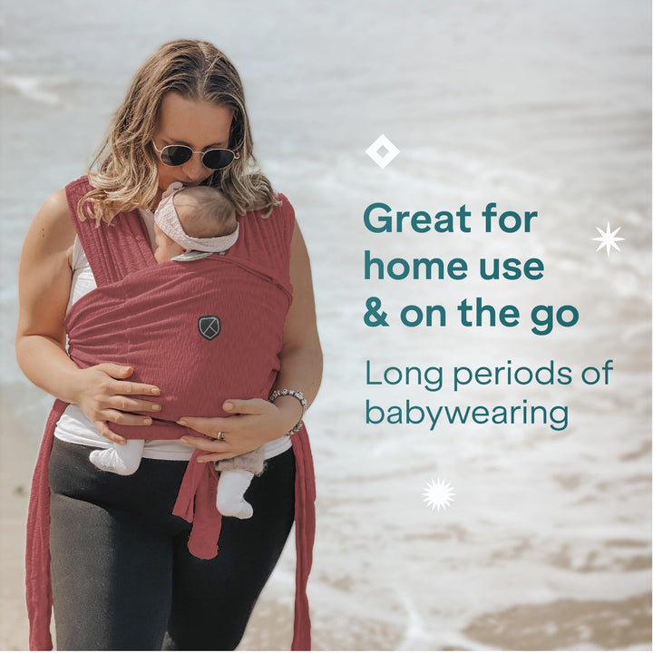 Mother using Koala Babycare Koala Cuddle Band in bordeaux, ideal for home use and on-the-go, designed for long periods of babywearing.