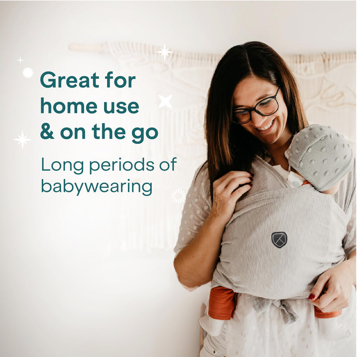 Mother using Koala Babycare Koala Cuddle Band in light gray, ideal for home use and on-the-go, designed for long periods of babywearing.