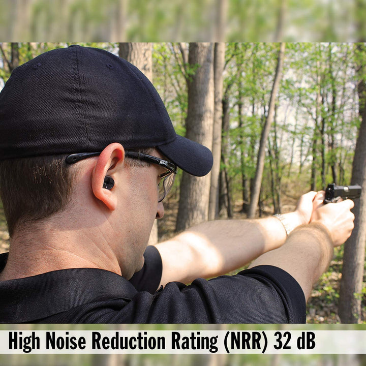 Shooter wearing Mack's Covert Ops Soft Foam Shooting Earplugs with NRR 32 dB hearing protection during target practice