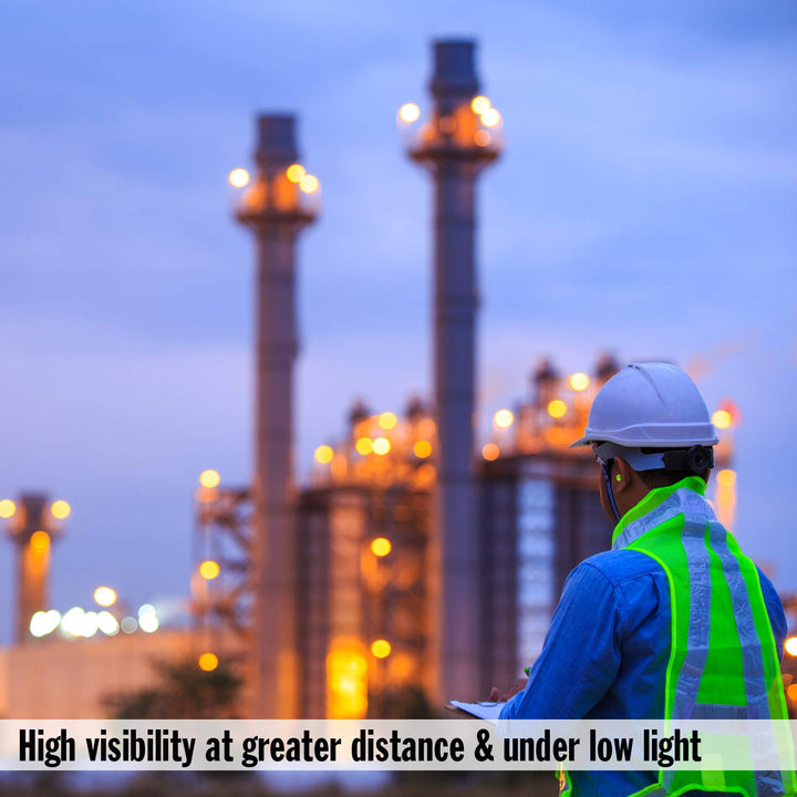 Worker wearing Mack's Hi Viz Soft Foam Earplugs NRR 32dB in low-light industrial environment