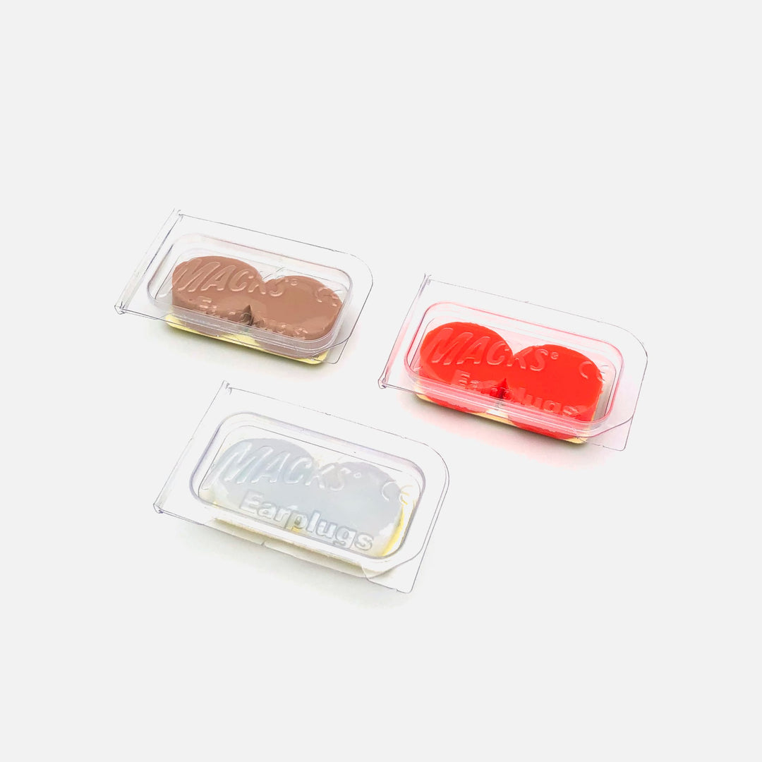 Mack's Pillow Soft Silicone Earplugs 1 Pair Trial Packs in white, beige, and orange, displayed in clear storage cases.